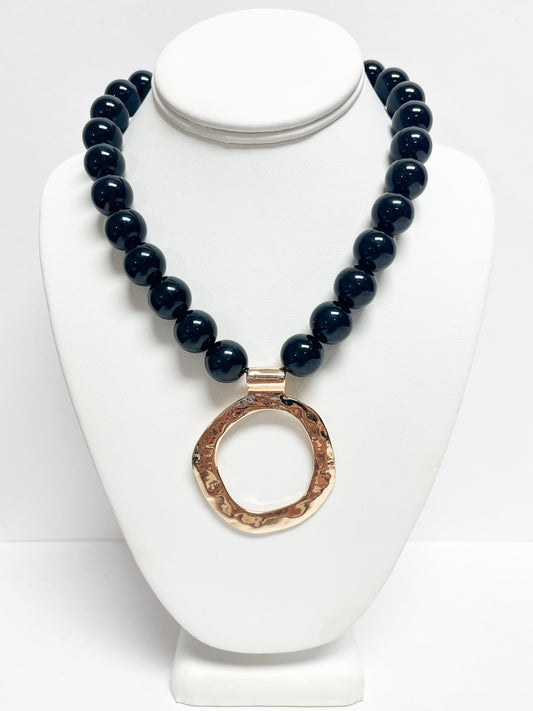 Black beaded hammered circle pendant necklace